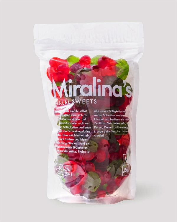 Eine Tüte Miralina's Halal-Süßigkeiten gefüllt mit roten und grünen Fruchtgummis